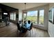 Bright dining area with a modern light fixture, a glass table, and lots of natural light at 653 Glenarbor Cir, Longmont, CO 80504