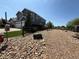 Landscaped backyard with gravel and large rocks surrounding the home at 653 Glenarbor Cir, Longmont, CO 80504
