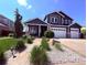 Charming two-story home features a three-car garage and welcoming landscaped front yard at 653 Glenarbor Cir, Longmont, CO 80504