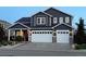 Charming two-story home with a two-car garage, stone accents, and a well-maintained front yard at 653 Glenarbor Cir, Longmont, CO 80504