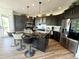 Modern kitchen with dark cabinetry, granite countertops, and stainless steel appliances at 653 Glenarbor Cir, Longmont, CO 80504