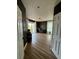 Inviting living room showcasing wood floors, black accent wall, a modern console, natural light, and decor at 653 Glenarbor Cir, Longmont, CO 80504