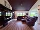 Comfortable living room with a modern entertainment center, large windows, and wood flooring at 653 Glenarbor Cir, Longmont, CO 80504