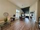 Spacious living room featuring a vaulted ceiling, dining area, and wood-look floors with an open floorplan at 653 Glenarbor Cir, Longmont, CO 80504