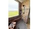 Updated tile shower features stone flooring, built-in shelf, rainfall shower head, and window at 653 Glenarbor Cir, Longmont, CO 80504