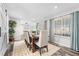 Bright dining room with a rustic wooden table, upholstered chairs, and large windows for natural light at 4733 S Vivian Ct, Morrison, CO 80465