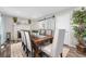 Elegant dining room featuring a stone fireplace, white mantle, and seating for six, illuminated by recessed lighting at 4733 S Vivian Ct, Morrison, CO 80465