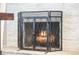 Fireplace featuring a protective metal screen, providing both safety and aesthetic appeal at 4733 S Vivian Ct, Morrison, CO 80465