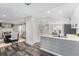 Modern kitchen boasts gray cabinets, an undermount sink, and stainless steel appliances, adjacent to a dining area at 4733 S Vivian Ct, Morrison, CO 80465