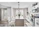 Bright kitchen featuring a center island with bar seating and modern lighting fixtures at 4733 S Vivian Ct, Morrison, CO 80465