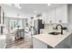 Bright, open kitchen featuring white cabinets, stainless steel appliances, and center island at 4733 S Vivian Ct, Morrison, CO 80465