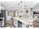 Open concept kitchen featuring a spacious island with seating and modern light fixtures at 4733 S Vivian Ct, Morrison, CO 80465