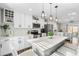 Modern kitchen with white cabinetry, stainless steel appliances, and a large island with seating at 4733 S Vivian Ct, Morrison, CO 80465