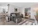 Inviting living room with a comfortable gray sofa and open access to the dining and kitchen areas at 4733 S Vivian Ct, Morrison, CO 80465