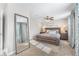 Bright bedroom with a ceiling fan, carpet floors, and natural light from the large windows at 4733 S Vivian Ct, Morrison, CO 80465