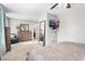 Spacious bedroom featuring a sitting area, TV, and carpet flooring with access to the ensuite bathroom at 4733 S Vivian Ct, Morrison, CO 80465