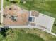 Aerial shot showcases playground with slides, swings, and a basketball court within a lush green park area at 4733 S Vivian Ct, Morrison, CO 80465