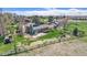 Aerial view of home showcasing expansive yard with a deck, hot tub, fencing, and mature landscaping at 7701 Hillgate Way, Parker, CO 80134