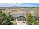 Expansive aerial view showcasing the home's setting with mountain views, mature trees, and large lot at 7701 Hillgate Way, Parker, CO 80134