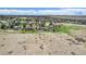 Aerial view of a home with expansive yard, mature trees, a deck, a hot tub, and surrounding landscape at 7701 Hillgate Way, Parker, CO 80134