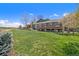 Exterior of home showing expansive yard, back deck, mature trees, and serene views at 7701 Hillgate Way, Parker, CO 80134