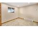 View of the basement area featuring tile flooring, a window and baseboard heating for comfortable living at 7701 Hillgate Way, Parker, CO 80134