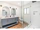 Bathroom features double sinks, modern tile, sleek glass shower and modern lighting at 7701 Hillgate Way, Parker, CO 80134