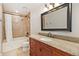 Bathroom features granite counters, a soaking tub, neutral tile, and a decorative mirror at 7701 Hillgate Way, Parker, CO 80134