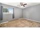 Bedroom features carpet, neutral gray walls, baseboard heaters and a bright, sunny window at 7701 Hillgate Way, Parker, CO 80134