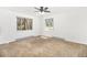 This bedroom features carpet, baseboard heaters, neutral walls and two sunlit windows with views at 7701 Hillgate Way, Parker, CO 80134