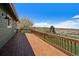 Inviting deck with wood railings and open views of the lush green yard and expansive open landscape beyond at 7701 Hillgate Way, Parker, CO 80134