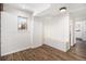 Bright entryway with built-in bench, wood-look floors, and a window looking outdoors at 7701 Hillgate Way, Parker, CO 80134