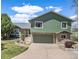 Charming two-story home with stone accents, well-maintained lawn, and a driveway leading to the garage at 7701 Hillgate Way, Parker, CO 80134