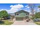 Inviting two-story home with stone accents, well-maintained lawn, and a driveway leading to the garage at 7701 Hillgate Way, Parker, CO 80134