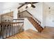 Bright foyer featuring hardwood floors, an open staircase, and a glimpse of the stone fireplace at 7701 Hillgate Way, Parker, CO 80134
