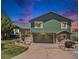 Charming two-story home with a stone-accented facade, attached garage, and beautifully landscaped front yard at 7701 Hillgate Way, Parker, CO 80134