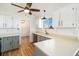 Charming kitchen with brick walls, white cabinets, modern appliances, and ample counter space at 7701 Hillgate Way, Parker, CO 80134