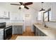 Charming kitchen with brick walls, white cabinets, modern appliances, and ample counter space at 7701 Hillgate Way, Parker, CO 80134