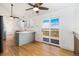Open kitchen with painted brick, light countertops, and access to the outdoor deck at 7701 Hillgate Way, Parker, CO 80134
