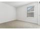 Neutral carpeted bedroom with large window allowing for plenty of natural light at 42984 Colonial Trl, Elizabeth, CO 80107