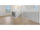 Bright landing area featuring hardwood floors, natural light and a decorative iron railing at 42984 Colonial Trl, Elizabeth, CO 80107