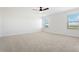Spacious carpeted main bedroom with ceiling fan and natural light at 42984 Colonial Trl, Elizabeth, CO 80107