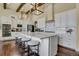 Spacious kitchen featuring white cabinets, large island, and stainless steel appliances at 10510 Ladera Dr, Lone Tree, CO 80124