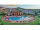 Community pool with lounge chairs and umbrellas at 10510 Ladera Dr, Lone Tree, CO 80124