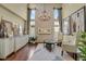 Spacious sitting area with stone fireplace and chandelier at 10510 Ladera Dr, Lone Tree, CO 80124