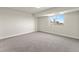 This bedroom features neutral carpet, light walls, and a large window with city views at 800 N Washington St # 1010, Denver, CO 80203