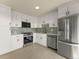 Modern kitchen featuring stainless steel appliances, light cabinets, and a subway tile backsplash at 800 N Washington St # 1010, Denver, CO 80203
