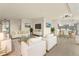 Bright living room featuring white furniture, gold accents, and an open floor plan with view of the kitchen at 800 N Washington St # 1010, Denver, CO 80203