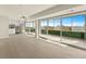 Open living space featuring sliding glass doors, light hardwood floors, and an adjacent kitchen at 800 N Washington St # 1010, Denver, CO 80203