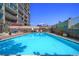 Beautiful outdoor pool with clear blue water, surrounded by lounge chairs and greenery at 800 N Washington St # 1010, Denver, CO 80203
